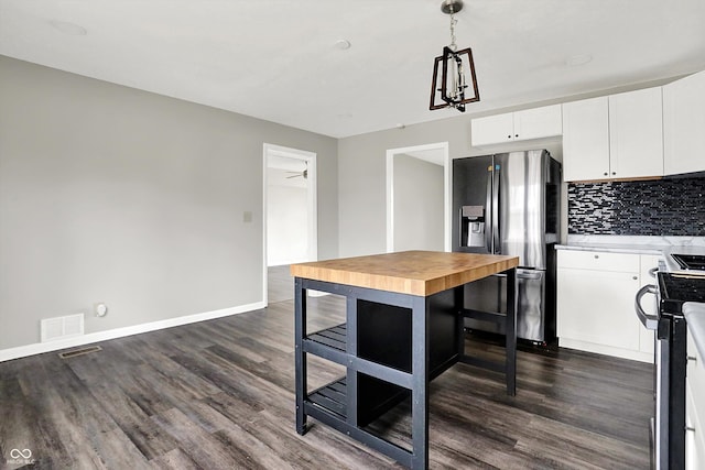 8902 Carla Dr, Indianapolis, IN 46219 - kitchen featuring dark hardwood / wood-style flooring, decorative light fixtures, stainless steel appliances, and white cabinets