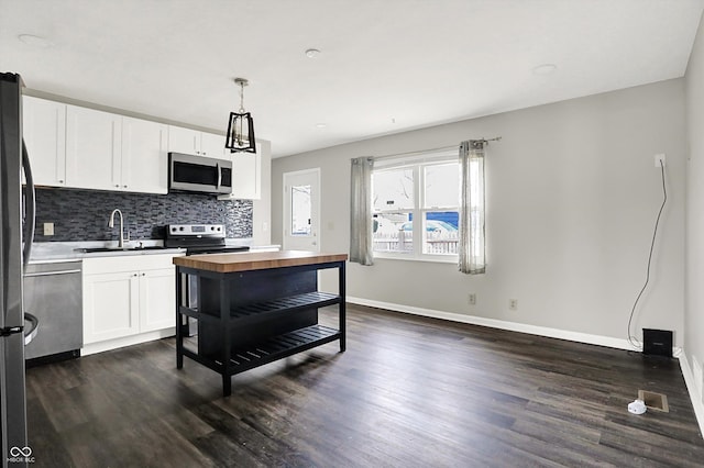 8902 Carla Dr, Indianapolis, IN 46219 - kitchen featuring stainless steel appliances, butcher block counters, sink, and white cabinets
