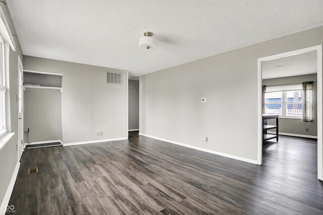 8902 Carla Dr, Indianapolis, IN 46219 - unfurnished bedroom featuring dark wood-type flooring, a closet, and a textured ceiling
