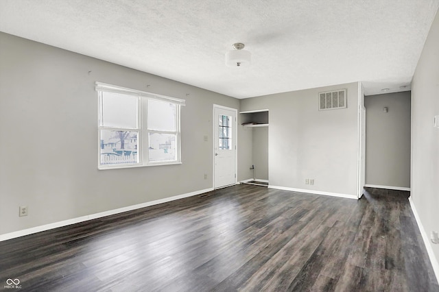 8902 Carla Dr, Indianapolis, IN 46219 - empty room with dark hardwood / wood-style floors and a textured ceiling