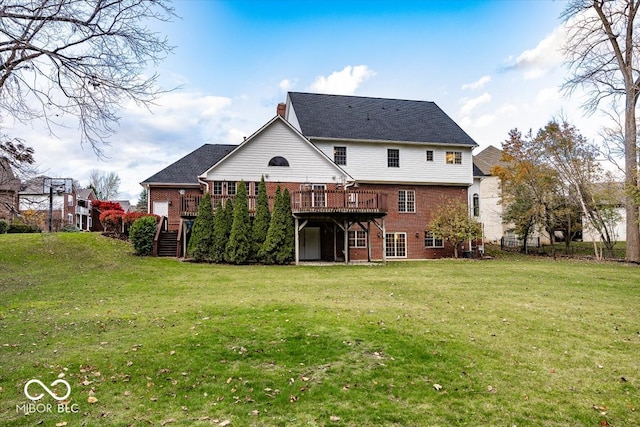 back of property featuring a deck and a yard