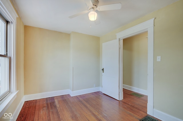 unfurnished room with ceiling fan and hardwood / wood-style floors