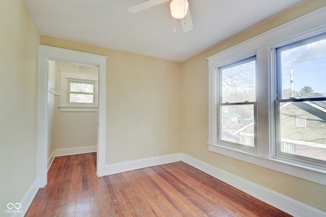 empty room featuring ceiling fan and dark hardwood / wood-style flooring