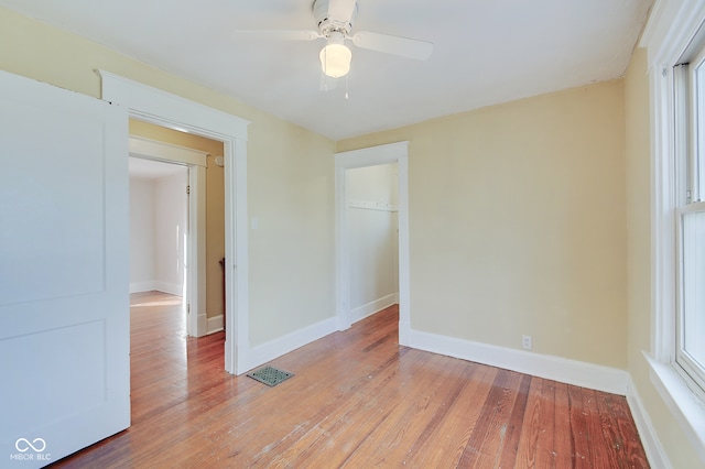 empty room featuring light wood-type flooring and ceiling fan