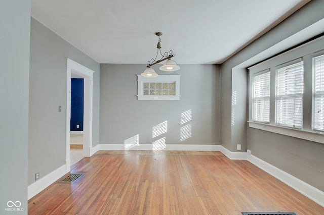 unfurnished room with light wood-type flooring