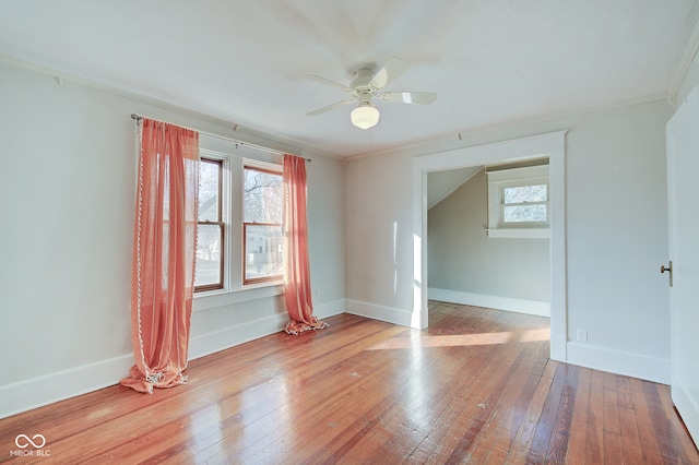 empty room featuring ceiling fan, ornamental molding, and light hardwood / wood-style flooring