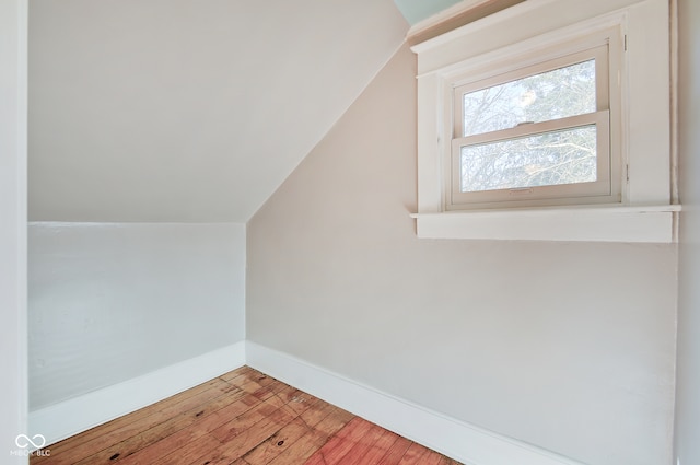 bonus room with hardwood / wood-style floors and lofted ceiling