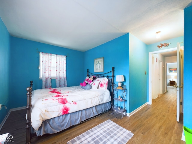 bedroom with hardwood / wood-style flooring