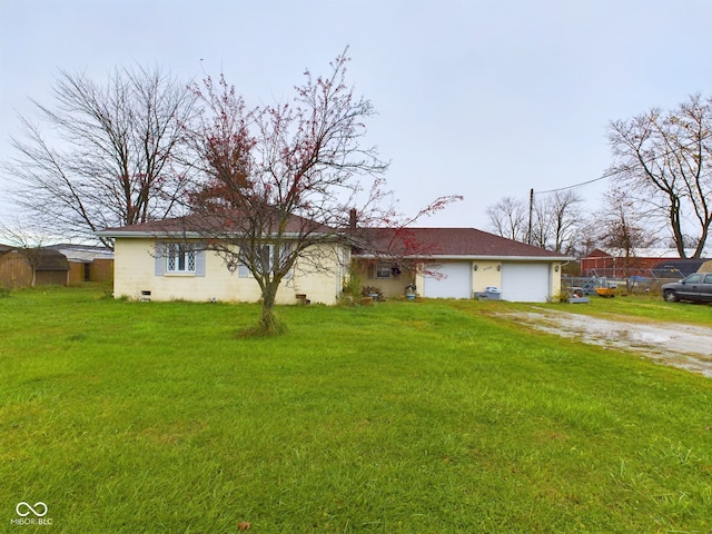 ranch-style house with a garage and a front yard