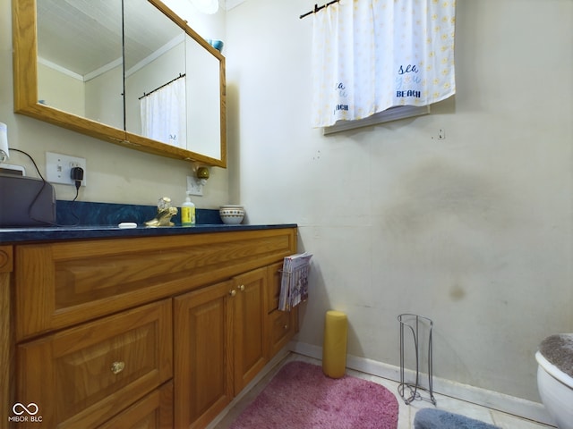 bathroom featuring toilet, vanity, and tile patterned floors