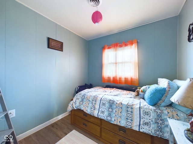 bedroom with hardwood / wood-style flooring