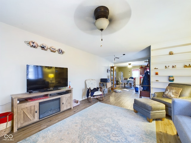 living room featuring ceiling fan and hardwood / wood-style flooring