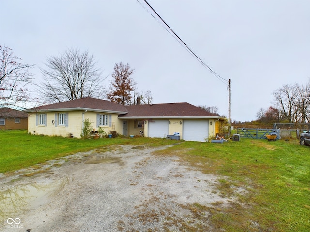 single story home featuring a garage and a front lawn