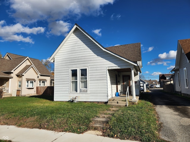 bungalow-style home with a front yard