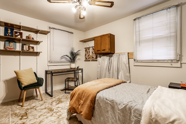 carpeted bedroom featuring ceiling fan and multiple windows