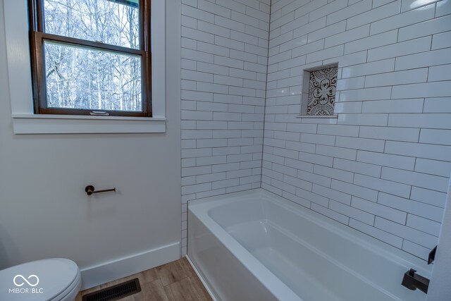 bathroom with hardwood / wood-style floors and toilet