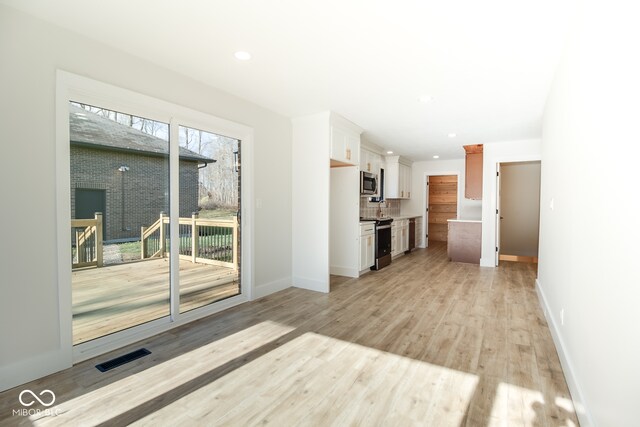 unfurnished living room featuring light hardwood / wood-style flooring