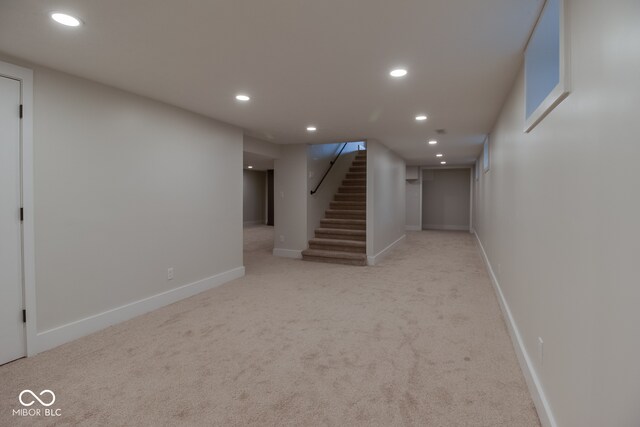 basement featuring light colored carpet