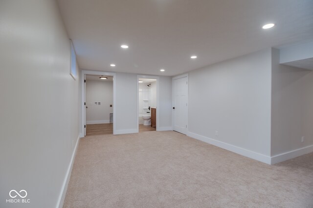 basement featuring light colored carpet