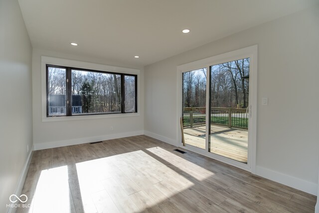 spare room featuring light hardwood / wood-style flooring