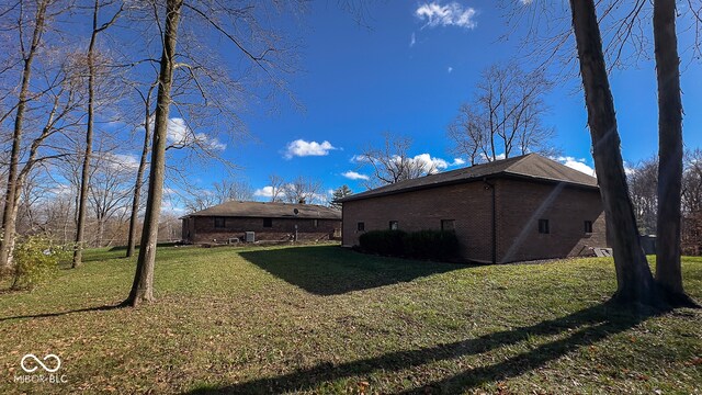 rear view of property featuring a yard