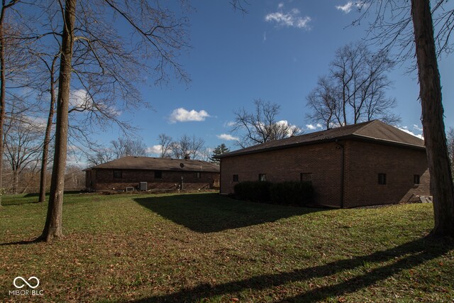 rear view of property with a yard