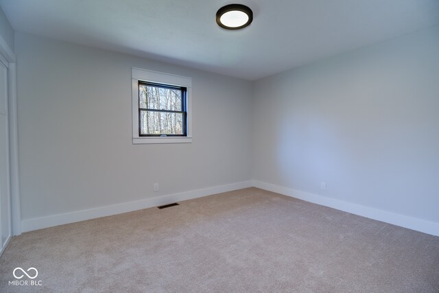 empty room featuring light colored carpet