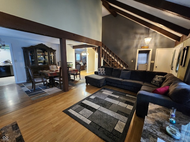 living room with wood-type flooring, beam ceiling, high vaulted ceiling, and a notable chandelier