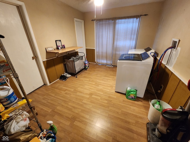 clothes washing area with washer hookup and light hardwood / wood-style floors