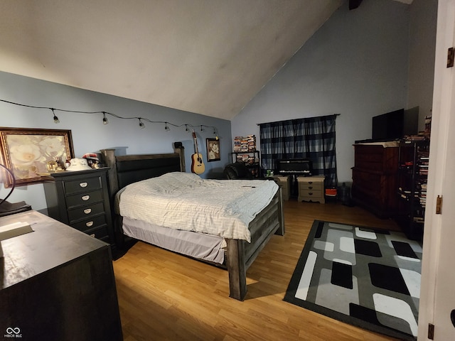 bedroom featuring vaulted ceiling and light hardwood / wood-style floors