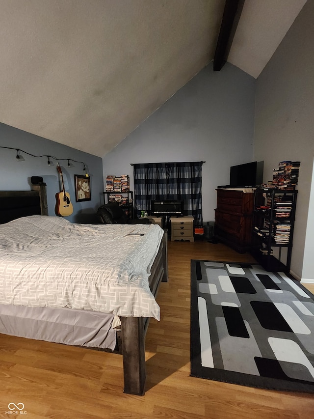 bedroom featuring wood-type flooring and lofted ceiling with beams