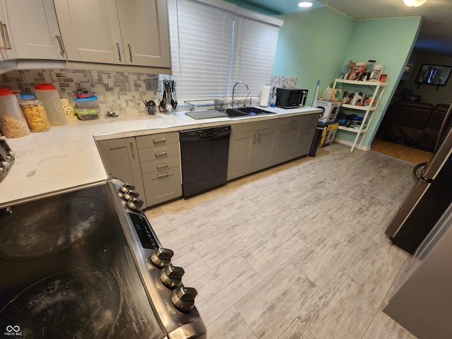 kitchen featuring backsplash, stainless steel electric stove, black dishwasher, and gray cabinetry