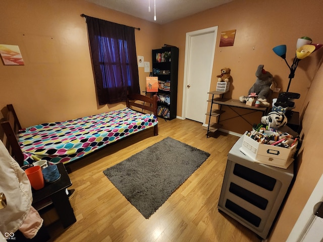 bedroom with wood-type flooring