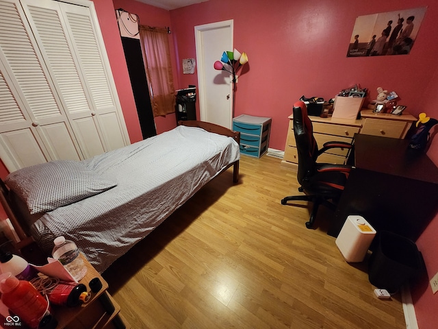 bedroom with a closet and light hardwood / wood-style flooring