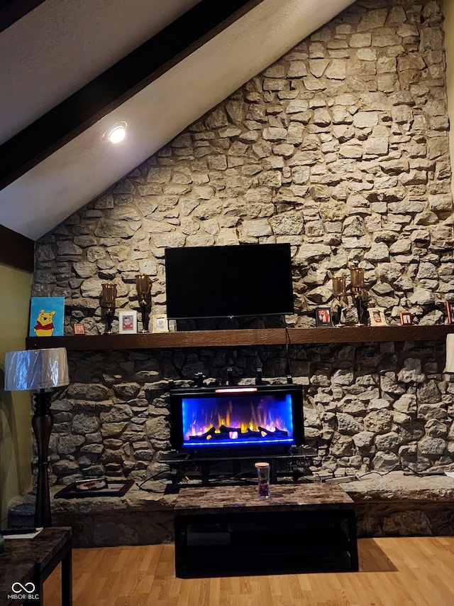 living room with vaulted ceiling with beams and hardwood / wood-style floors