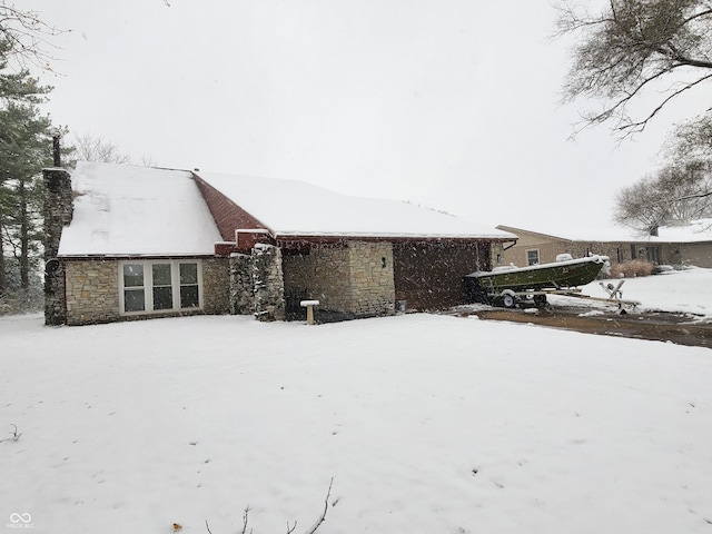 view of snow covered rear of property