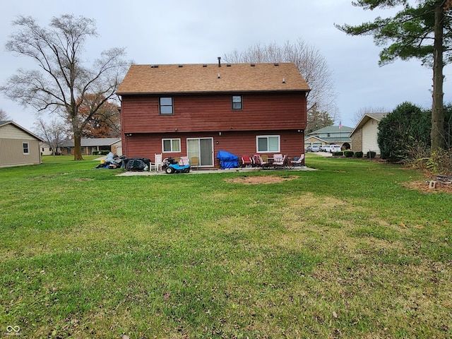 back of house with a patio and a lawn