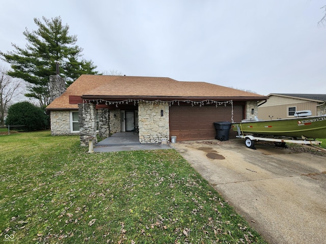 rear view of house featuring a garage and a lawn