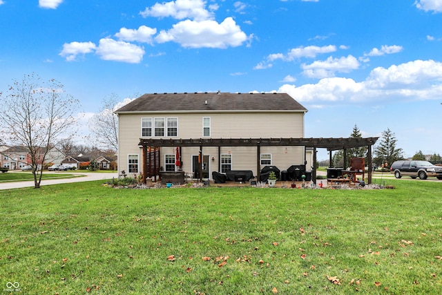 rear view of house featuring a lawn and a pergola