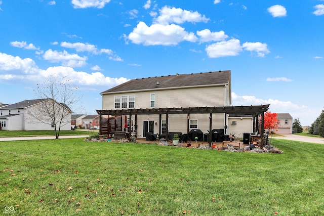 back of house with a yard and a pergola