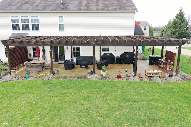 rear view of property with a pergola, a yard, and a patio