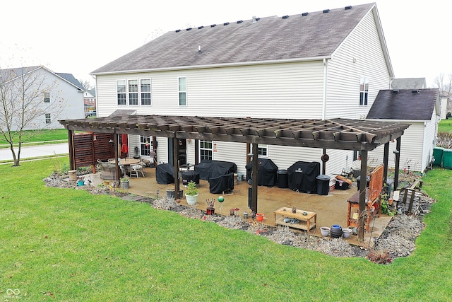 rear view of house featuring a pergola, a patio area, and a lawn