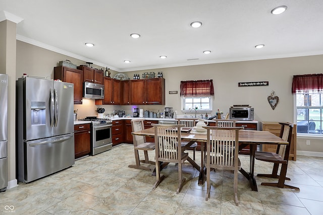 kitchen with ornamental molding, stainless steel appliances, a healthy amount of sunlight, and sink