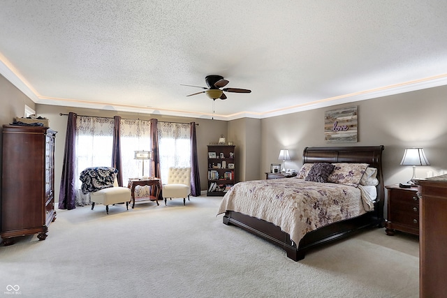 bedroom featuring a textured ceiling, ceiling fan, light colored carpet, and crown molding