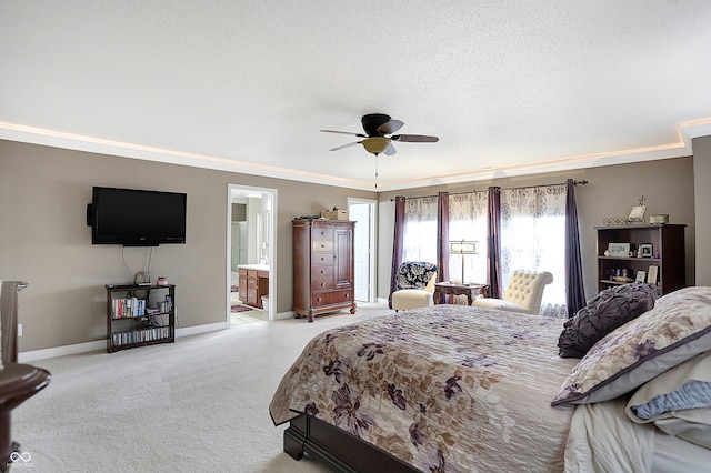 carpeted bedroom with ensuite bath, ceiling fan, a textured ceiling, and ornamental molding