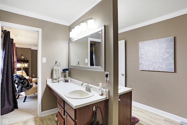 bathroom with vanity, wood-type flooring, and ornamental molding