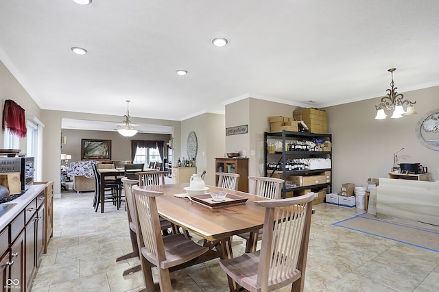 dining area featuring crown molding and a chandelier