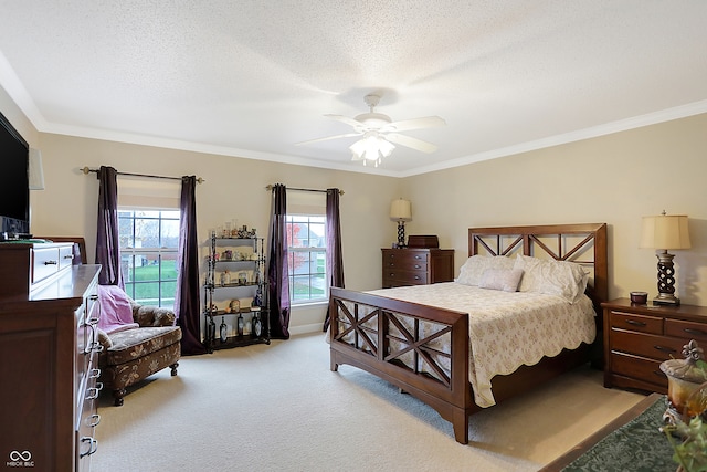 carpeted bedroom with ceiling fan, crown molding, and a textured ceiling