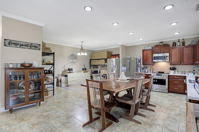 dining space featuring ornamental molding and an inviting chandelier