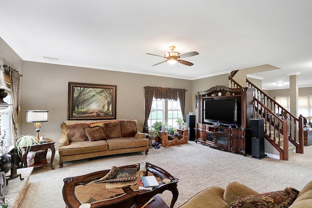 carpeted living room featuring ceiling fan and ornamental molding